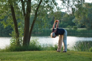 Senior man exercising next to a lake
