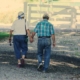 Old couple walking while holding hands
