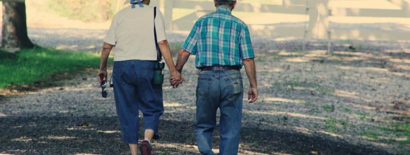Old couple walking while holding hands
