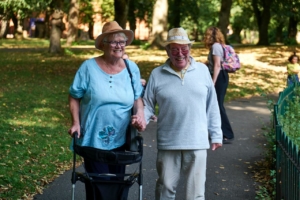 Senior couple walking in park in summer sunny day