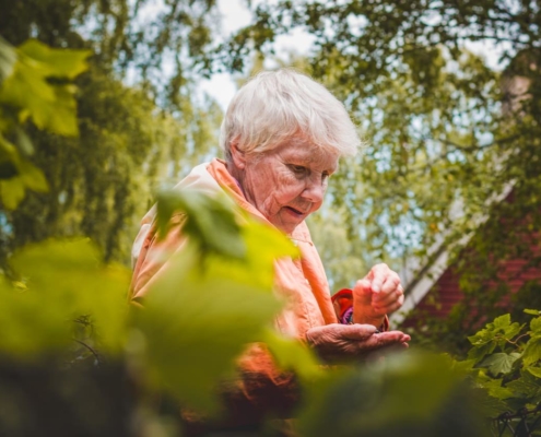 Older woman near plants