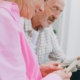 An elderly couple with gray hair looking at photos together